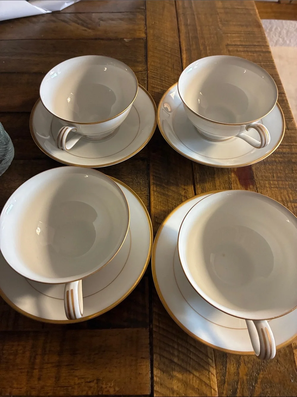 Noritake White Porcelain Teacup and Saucer Set with Gold Trim